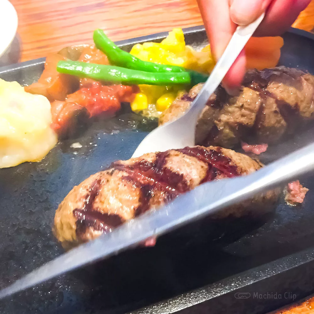 アルカサール 町田店のハンバーグを切っている写真